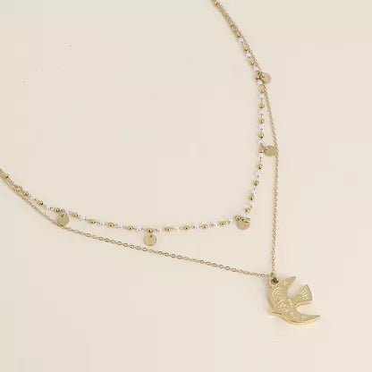 Collier 2 rangs - pendentif en forme d'oiseau, perles de résine blanche
